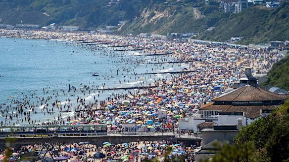 Crowds defied social distancing advice to swamp Bournemouth beach in southern England.
