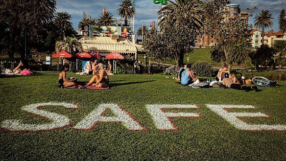 Melburnians enjoy the sun at St Kilda beach while social distancing.