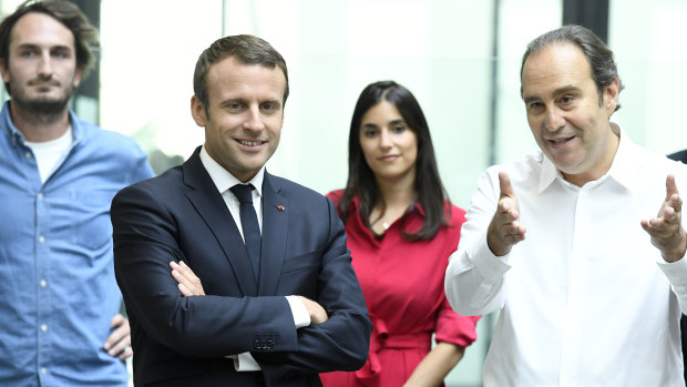 French telecom tycoon Xavier Niel, right, speaks with French President Emmanuel Macron.