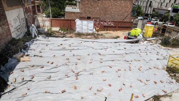 A crew removes further small remnants of asbestos from the Corkman site in Carlton on Thursday.