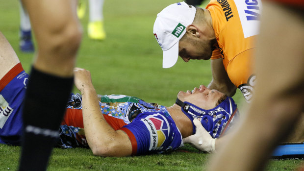 Target: Kalyn Ponga is treated after copping a heavy knock from Jared Waerea-Hargreaves.