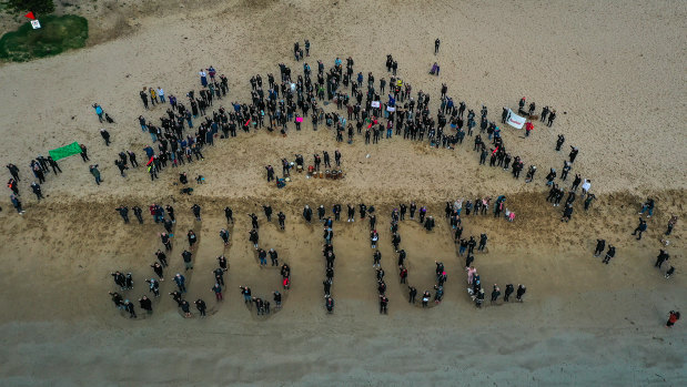 In Torquay rather than a march women gathered on the beach spelling out the word  ‘JUSTICE’ on the sand on Monday.