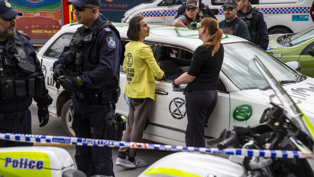 Extinction Rebellion activist Eric Herbert (centre) is seen participating in a protest outside 1 Williams Street.