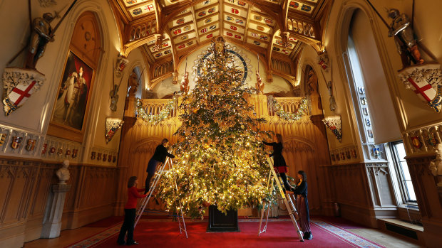 A six-metre-tall-tree being decorated in St George's Hall at Windsor Castle.