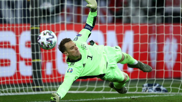 Manuel Neuer of Germany saves a penalty shot by Igor Stasevich.