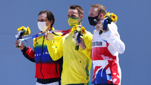 Silver medallist Daniel Dhers of Venezuela, gold medallist Logan Martin of Australia, and bronze medallist Declan Brooks of Great Britain on the podium after their men’s park final of the BMX freestyle in Tokyo.