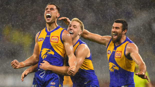 Singing in the rain: Nic Read celebrates a goal on debut for the Eagles amid a brief downpour at Optus Stadium in Perth.