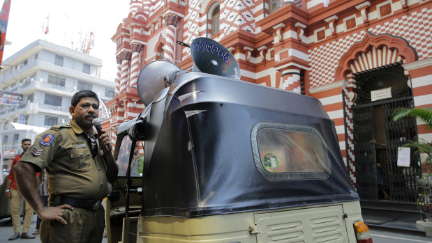 A Sri Lankan police officer announces security warnings outside Colombo's Red Mosque this week.