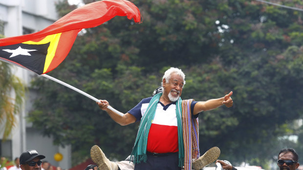 East Timorese independence hero Xanana Gusmao waves a national flag in Dili last month.