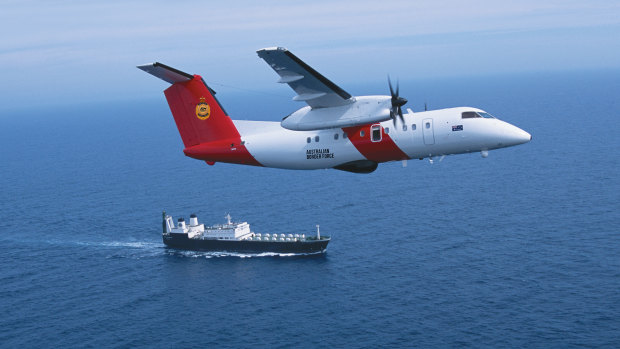 A Cobham Dash 8 aircraft, pictured above a Border Force ship, conducts aerial surveillance.