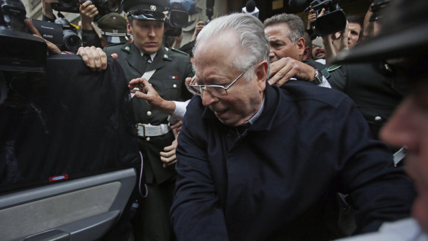Fernando Karadima is escorted from a court after testifying in a case that three of his victims brought against the Catholic Church in Santiago, Chile, in 2015.