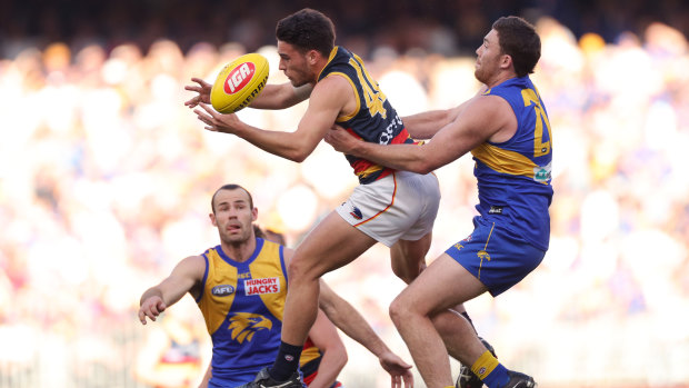 As the Crow flies: Eagle Jeremy McGovern attempts to take down Lachlan Murphy.