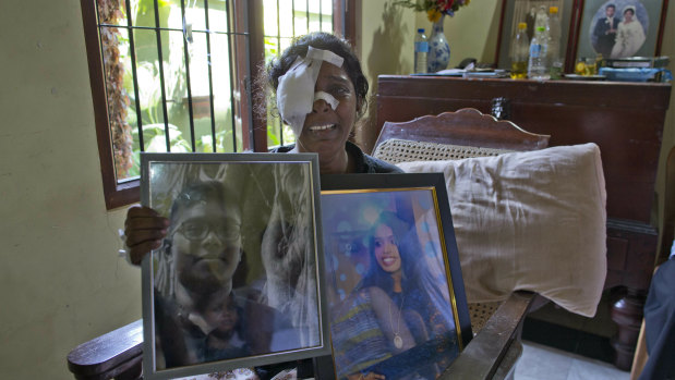 Anusha Kumari holds portraits of her daughter Sajini Venura Dulakshi and son Vimukthi Tharidu Appuhami, both victims of Easter Sunday's bomb blast in Negombo. Her husband was also killed in the attack.