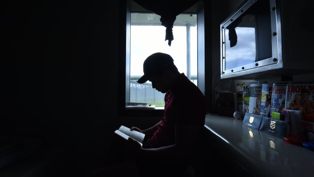 A detainee reads a book inside his room at Cobham Juvenile Justice Centre in Sydney's west. 