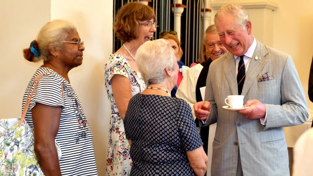 Charles meets with parishioners after the Sunday church service.