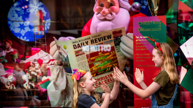 Santa catches up on the news in the Myer Christmas windows. 