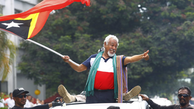 East Timorese independence hero Xanana Gusmao waves a national flag upon arrival in Dili in March.