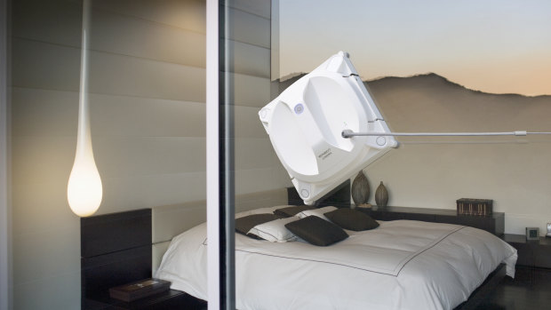 Interior of modern bedroom tethered to its safety pod, which attaches to the window with a suction cub, the winbot keeps a great grip.
