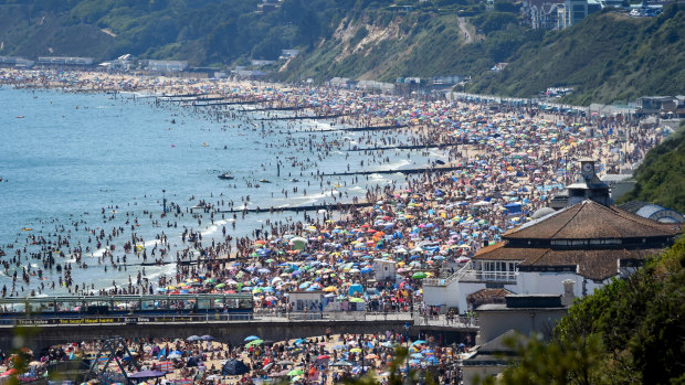 Crowds defied social distancing advice to swamp Bournemouth beach in southern England.