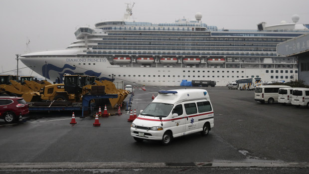 An ambulance leaves the port where the quarantined Diamond Princess cruise ship is docked. 