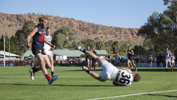 Jack Hombsch takes a diving mark during one of his games in Alice Springs.