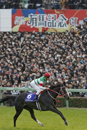 Damian Lane rides Lys Gracieux to victory in the Arima Kinen.
