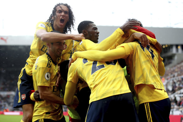 Arsenal players celebrate Pierre-Emerick Aubameyang's goal against Newcastle at St James' Park.