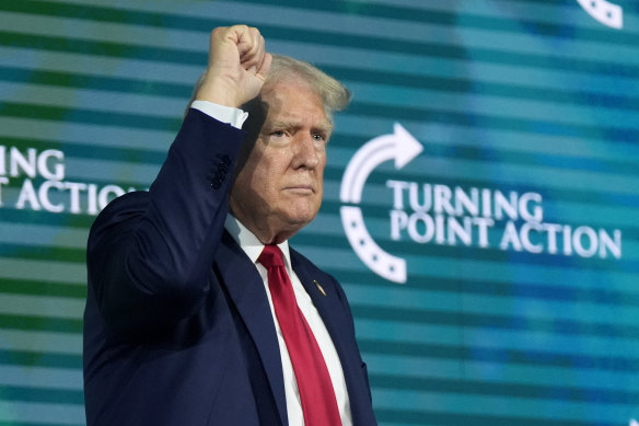 Republican presidential candidate Donald Trump gestures on stage at the Turning Point Believers’ Summit.