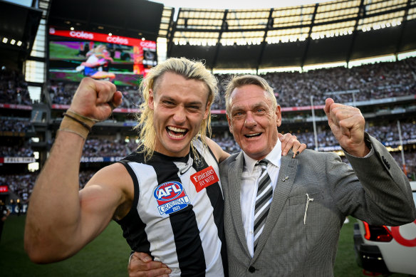 Darcy Moore and his father Peter celebrate the flag.