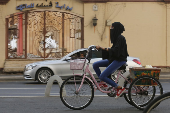 A Saudi Arabian woman rides a bicycle in Jeddah. Foreign women will be asked to dress modestly, but will not be forced to wear a niqab or abaya. 