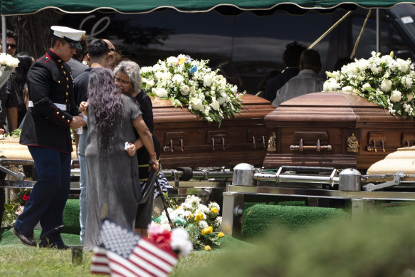 Two women comfort each other during the burial service for Irma Garcia and her husband Joe Garcia. Irma Garcia was killed in last week’s elementary school shooting. Joe Garcia died two days later. 