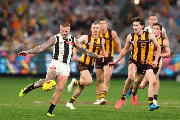 Jordan De Goey gets a kick away surrounded by Hawks on Saturday.
