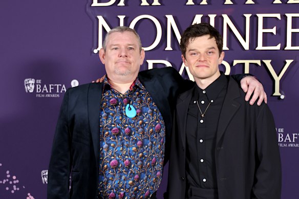 John Davidson (left) attended the BAFTAs to celebrate I Swear, a film inspired by his life starring Robert Aramayo (right).