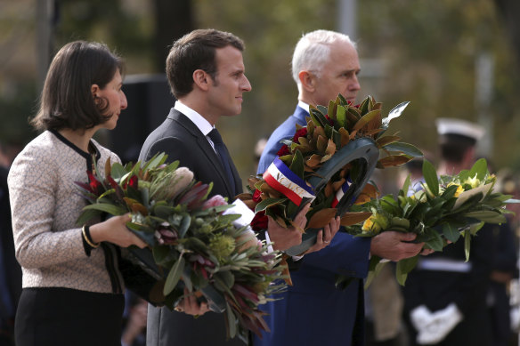 Former prime minister Malcom Turnbull used his National Press Club address to criticise the Federal Government’s decision to tear up a $90 billion contract with France for submarines. He is pictured here with NSW Premier Gladys Berejiklian and French President Emmanual Macron in Sydney in 2018. 