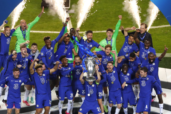 Chelsea players celebrate with the trophy after winning the Champions League final soccer match against Manchester City at the Dragao Stadium in Porto, Portugal.