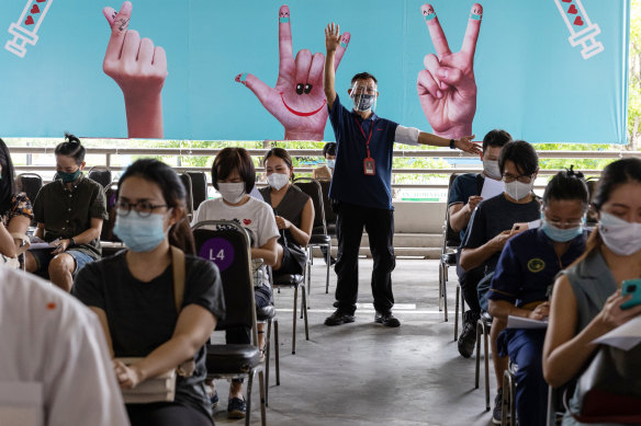 People wait in an observation area at a vaccination hub set up in a Bangkok shopping centre after receiving the AstraZeneca Covid-19 vaccine on Monday.