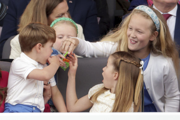 Prince Louis, Princess Charlotte and Savannah Phillips eat sweets, during the Platinum Jubilee Pageant held outside Buckingham Palace, in London.