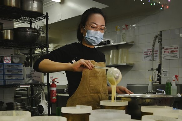 Naoka Kojo, co-creator of 15centimeters, prepares cheesecakes for baking. 