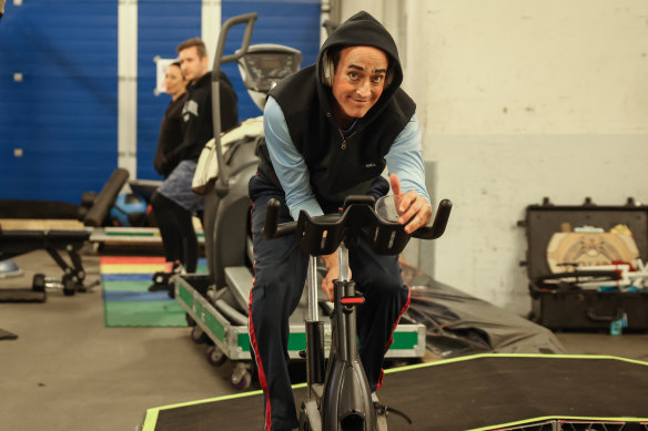 Clown Nathan Cooper works out backstage.