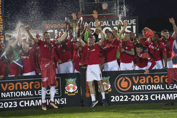 Wrexham players celebrate their promotion to the EFL after beating Boreham Wood.