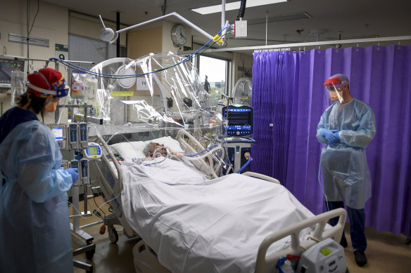An ICU nurse and an anaesthetist attend to a COVID-infected patient inside the ICU ward of Western Health’s Footscray Hospital last year. 