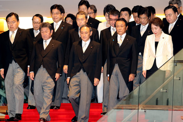 Yoshihide Suga, Japanese Prime Minister, front row centre, with his new cabinet members at his official residence in Tokyo, last week.