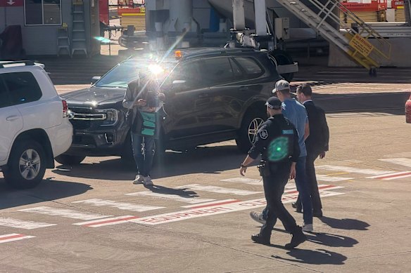 Ben Roberts-Smith is taken into custody after arriving at Sydney Airport on Tuesday.