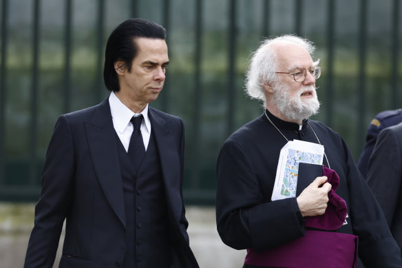 Nick Cave and former archbishop of Canterbury Rowan Williams arrive at Westminster Abbey ahead of the coronation. 