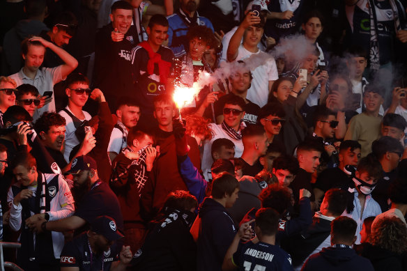 One of several flares is set off during the Melbourne derby.