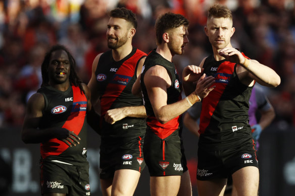 Shaun McKernan of the Bombers (right) celebrates a goal with teammates during Round 16 match this season.