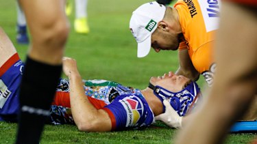 Target: Kalyn Ponga is treated after copping a heavy knock from Jared Waerea-Hargreaves.