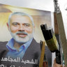 Yemeni protesters raise machine guns during a protest to condemn the killing of Ismail Haniyeh.