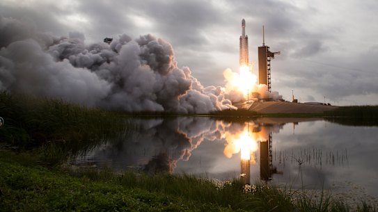 Private companies – like SpaceX, whose Falcon Heavy rocket is pictured carrying a satellite – have entered the space race.