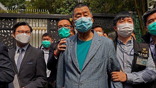 Apple Daily founder Jimmy Lai, centre, was arrested in April last year.